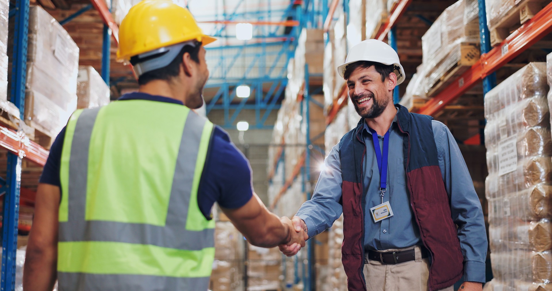 Men, shaking hands and warehouse for deal with logistics, smile and contract for global shipping company. People, handshake and happy for agreement, collaboration and supply chain for distribution